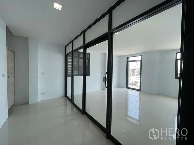 Factory for rent in Ban Phaeo, Samut Sakhon - Upper office level with glass partitions and bright tiled flooring.