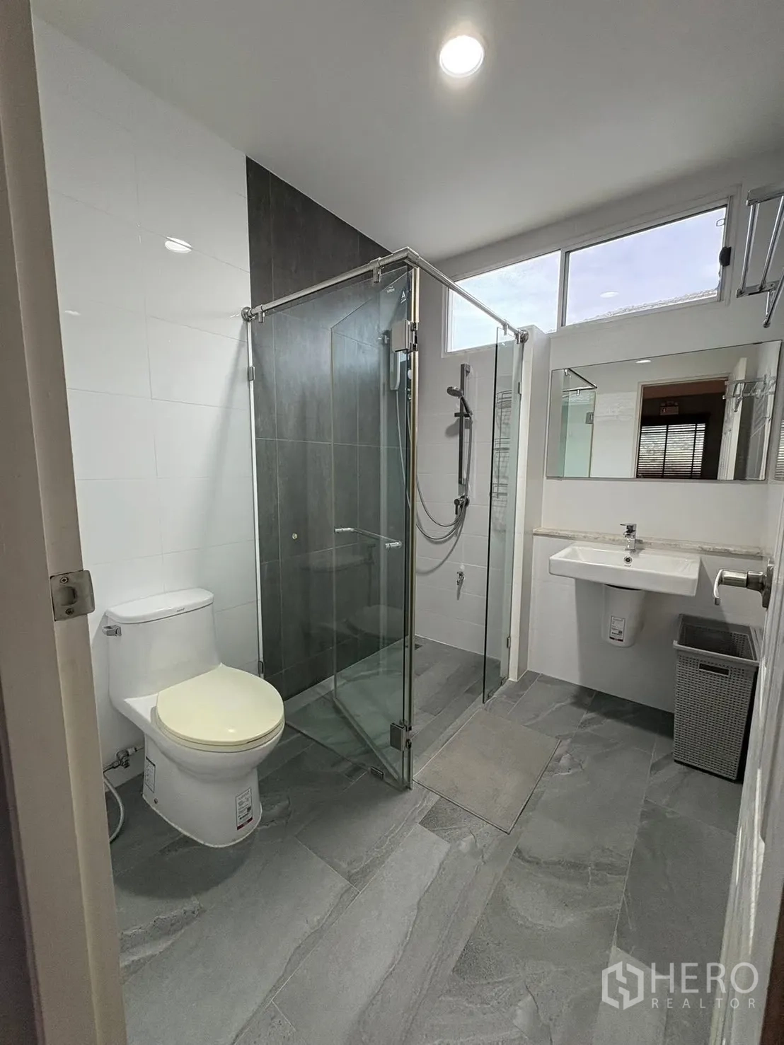 Detached House for rent in Prawet, Bangkok - Modern bathroom with glass shower enclosure, toilet and sink.