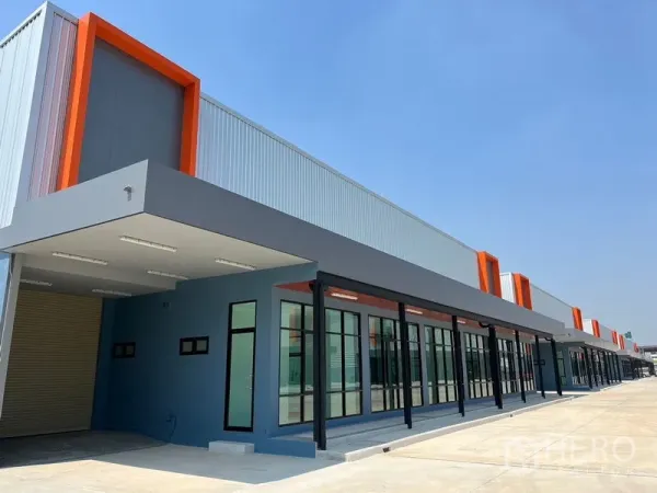 Warehouse for rent in Bang Phli, Samut Prakan - Close-up of unit entrance with glass doors, orange trim and covered loading area