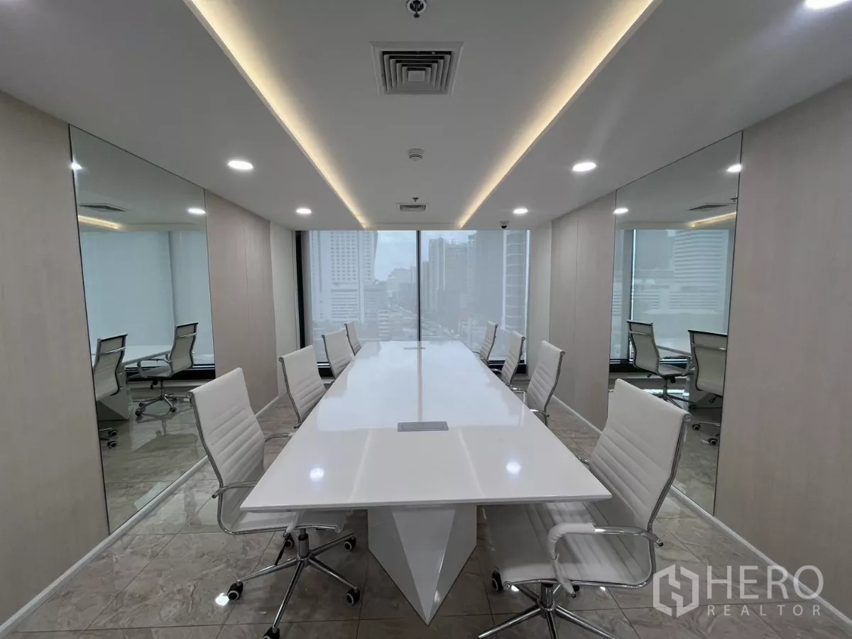 Office Space for rent in Din Daeng, Bangkok - Boardroom with floor-to-ceiling windows framing the Rama 9 skyline and sleek white chairs.