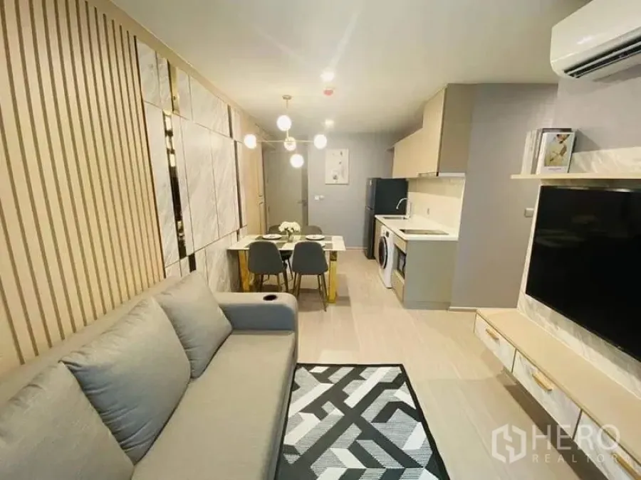 Condominium for rent - Another view of the open living–dining space with geometric rug and kitchenette.
