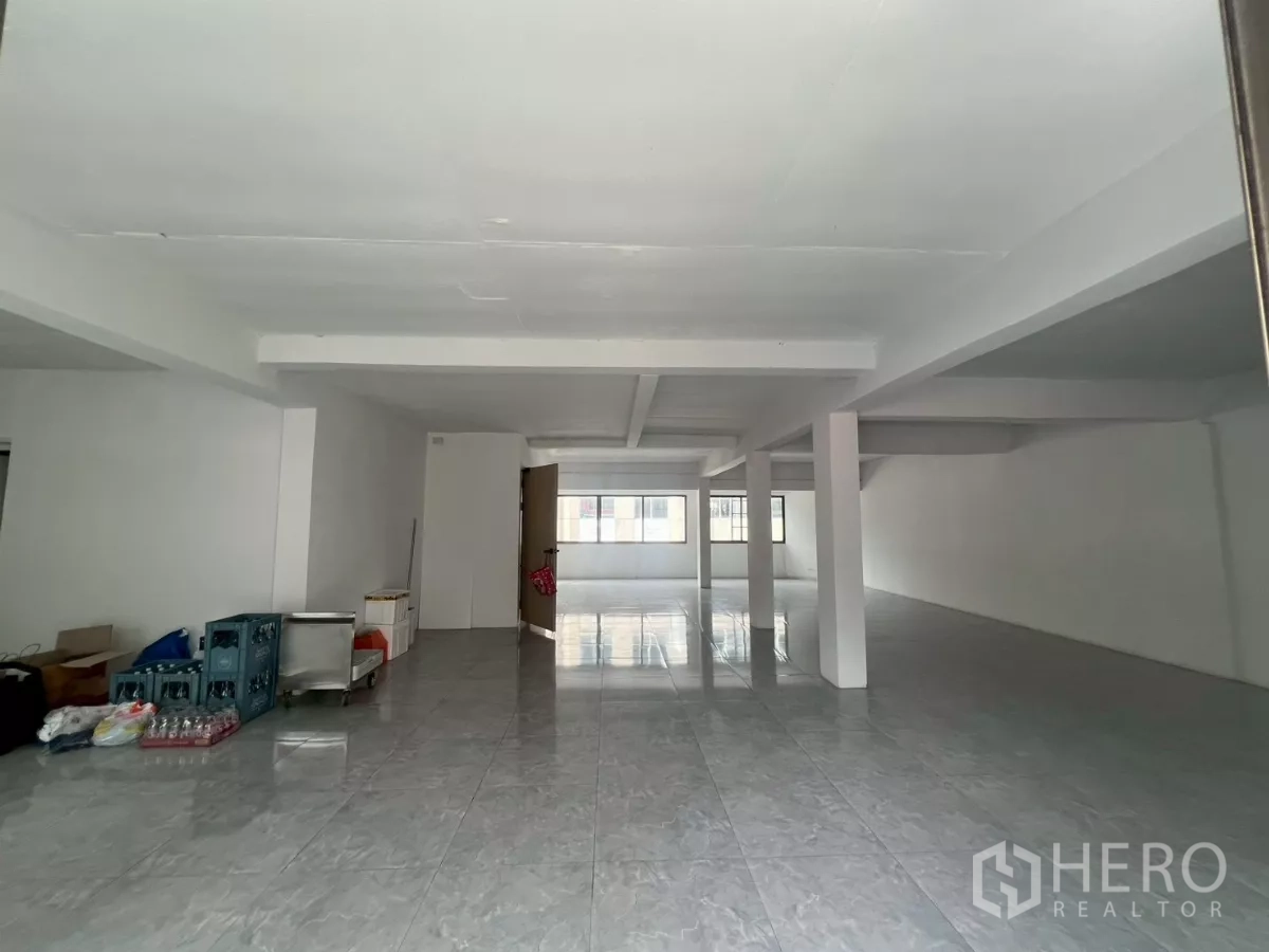 Retail Space for rent in Pathum Wan, Bangkok - Long open space with structural columns, tiled flooring, and natural light from both ends.