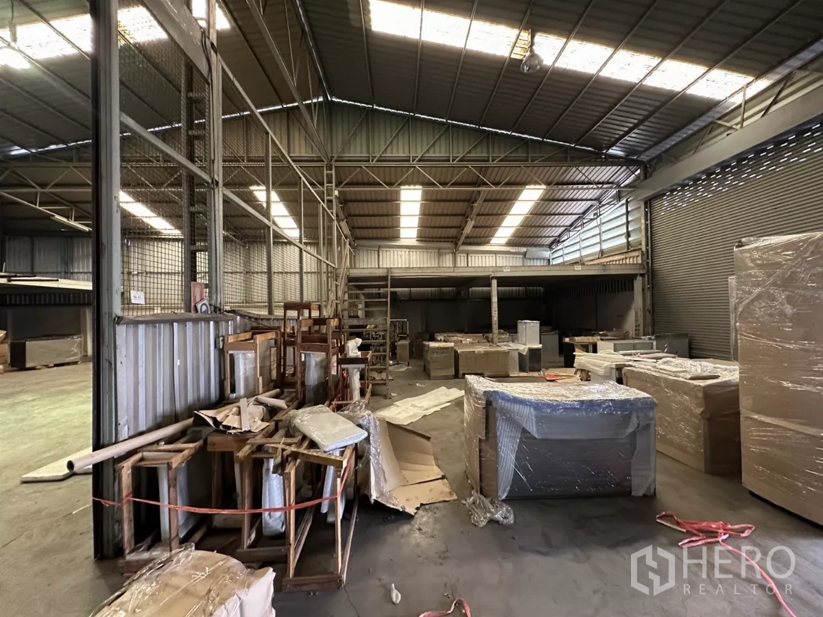 Warehouse for rent in Yan Nawa, Bangkok - Storage zone with wrapped pallets and materials under bright industrial lighting.