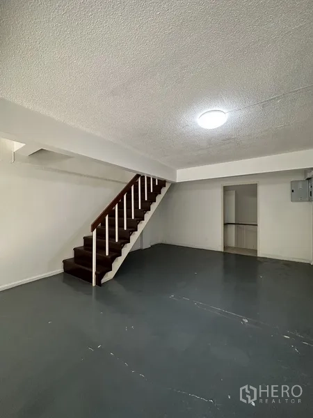 Retail Space for rent in Watthana, Bangkok - Ground-floor retail area with staircase, storage room, and smooth concrete floor.