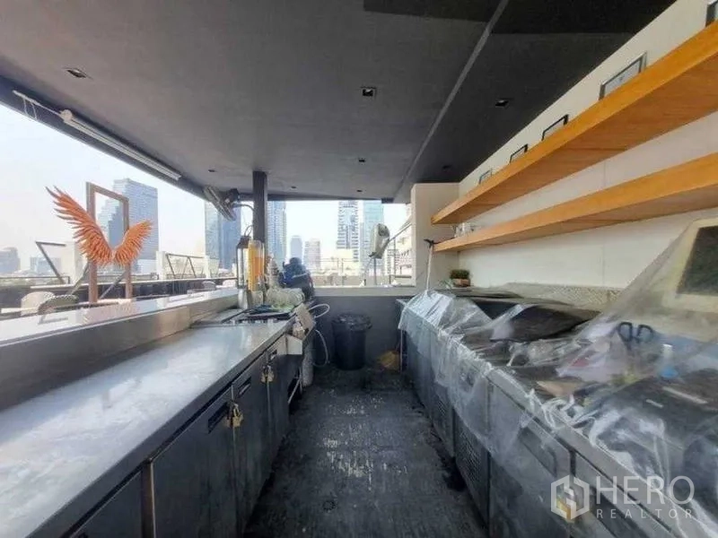 Retail Space for rent in Bang Rak, Bangkok - Outdoor rooftop bar counter with shelves and skyline backdrop.
