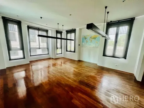 Office Space for rent in Khlong Toei, Bangkok - Bright open-plan office with polished wood floors, large windows and pendant lighting.