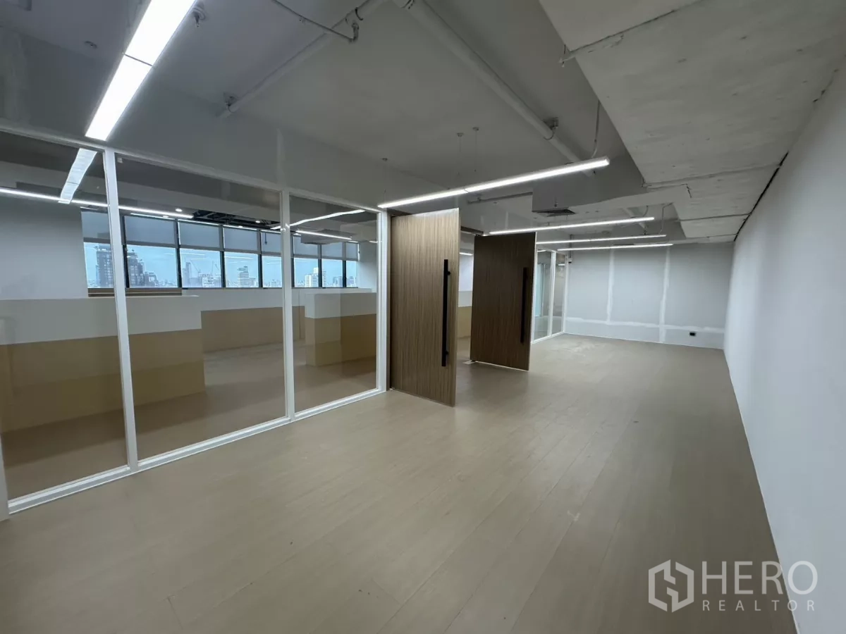 Office Space for rent in Watthana, Bangkok - Large room with pivot wood doors and full-height glass partitions.