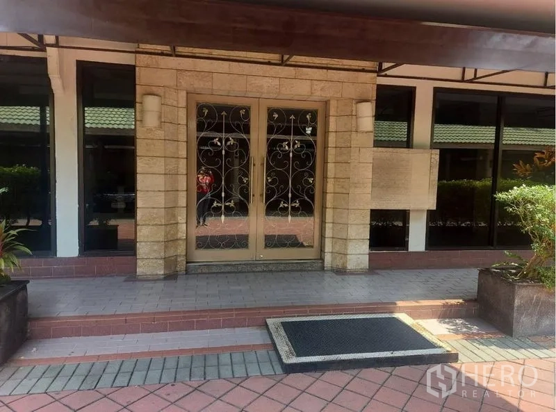 Retail Space for rent in Pathum Wan, Bangkok - Building entrance with double glass doors, wrought-iron detail and stone facade.