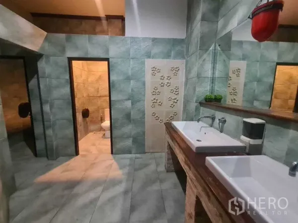 Retail Space for rent in Watthana, Bangkok - Restroom finished in green tiles with double rectangular sinks, mirror and two toilet cubicles.