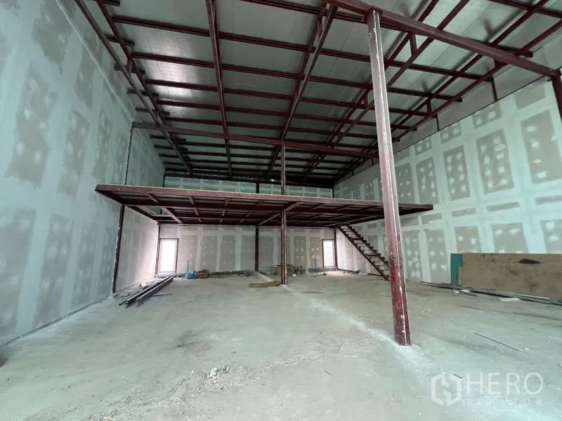 Retail Space for rent in Khlong Toei, Bangkok - Wide double-height hall with mezzanine and staircase, ready for tenant fit-out.