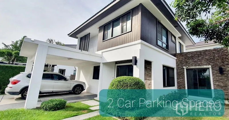 Detached House for rent in Bang Phli, Samut Prakan - Contemporary two-storey house exterior with covered two-car carport and manicured lawn