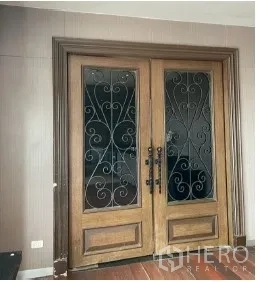 Retail Space for rent - Ornate wooden double doors with wrought-iron glass panels, creating a grand retail entrance.