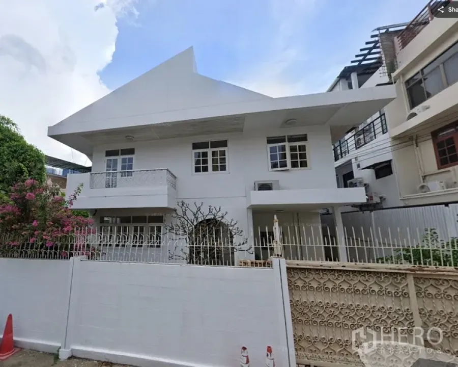 Detached House for rent or sale in Sathon, Bangkok - Two-story white detached house in Sathon with pitched roof, gated fence and front garden.