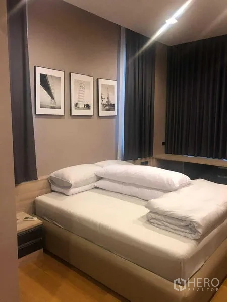 Detached House for rent or sale in Bang Kapi, Bangkok - Bedroom with double bed, grey curtains and framed artwork.