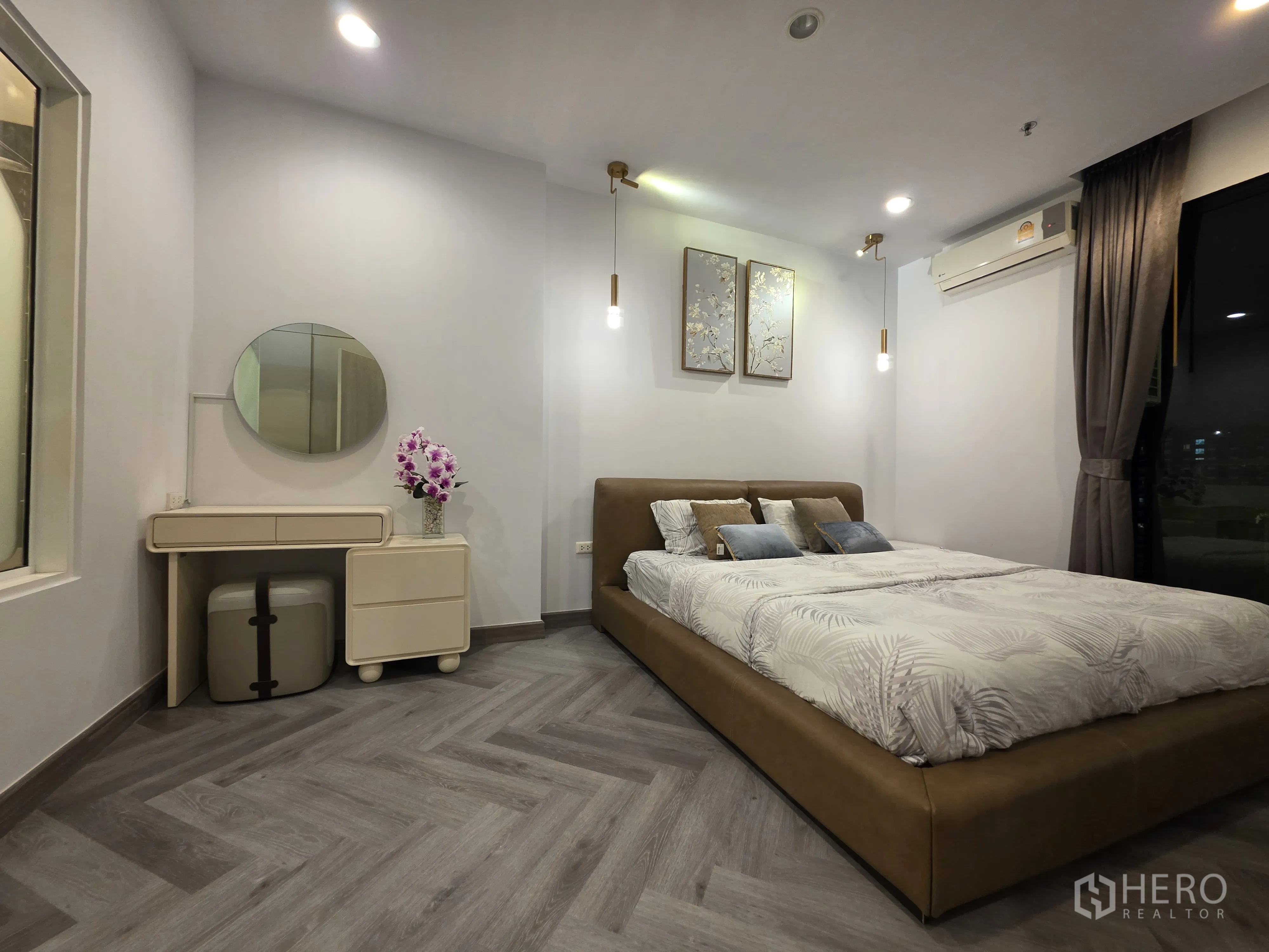 Condominium for rent in Bang Kapi, Bangkok - Bedroom with upholstered bed, pendant lights, vanity, and curtains.