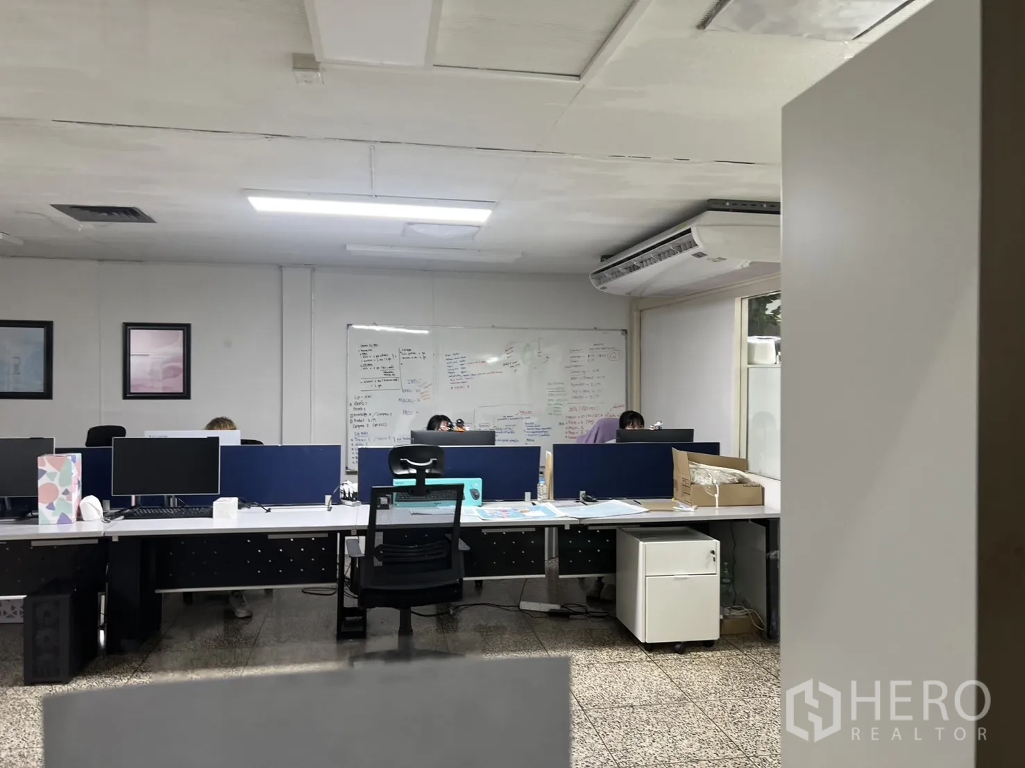 Shophouse for rent - Modern open-plan office with long workstations, whiteboard and split AC.