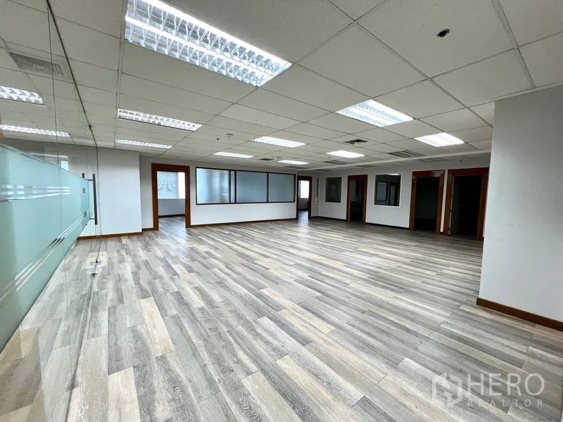 Office Space for rent in Watthana, Bangkok - Large office floor with vinyl plank flooring, recessed lighting and multiple private rooms.