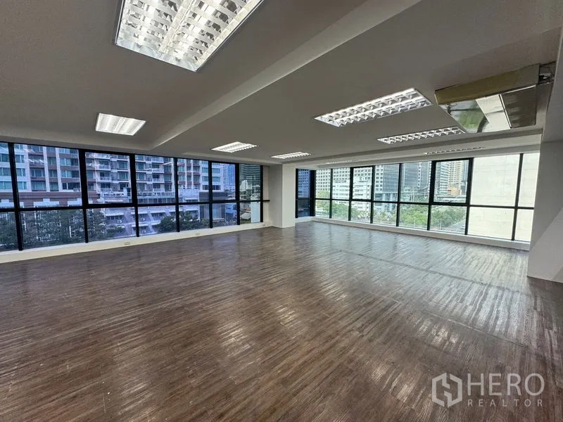Office Space for rent in Sathon, Bangkok - Corner office with panoramic city views through full-height glazing.