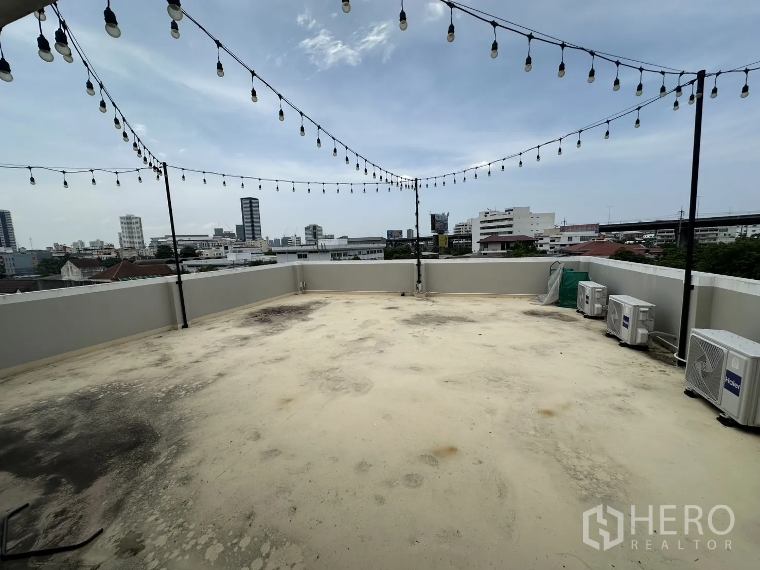 Home Office for rent or sale in Bang Na, Bangkok - Wide rooftop deck with string lights and skyline views of Bang Na.