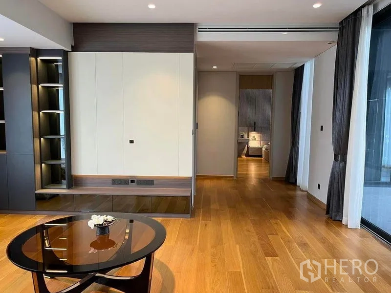 Detached House for sale in Suan Luang, Bangkok - Bright lounge with wood flooring, built-in shelving and sliding access to a bedroom.