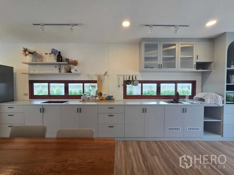 Home Office for rent - Close-up of kitchen cabinetry with open shelves and low horizontal windows.