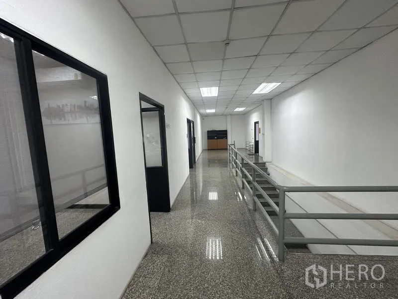 Warehouse for rent in Khlong Sam Wa, Bangkok - Office corridor with granite floor, handrail and multiple doorways.