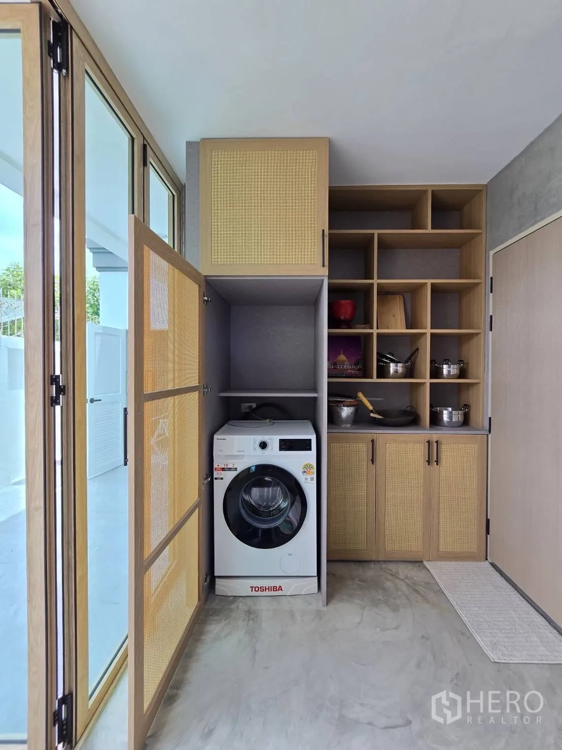 Detached House for sale in Suan Luang, Bangkok - Laundry and storage area with front-load washer and built-in cabinetry.