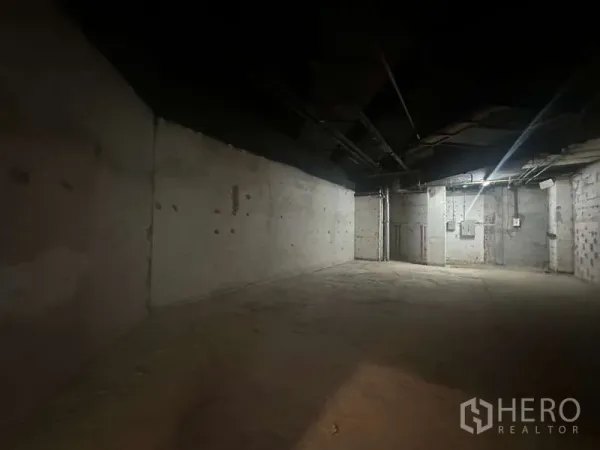 Retail Space for rent - Long rectangular empty room with bare concrete and visible ceiling services, suitable for retail build-out.