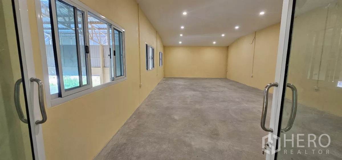 Warehouse for rent in Lat Krabang, Bangkok - Bright mezzanine office room with multiple windows and recessed lighting.