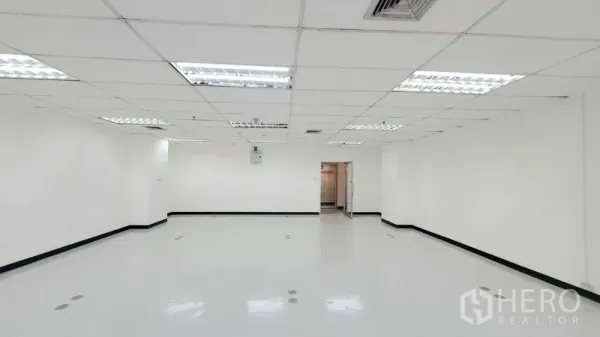 Office Space for rent in Watthana, Bangkok - Spacious empty office with white walls, ceiling lights, floor outlet points, and a glass entry door.