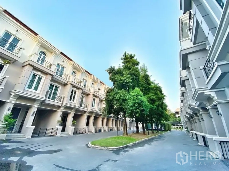 Townhouse for rent in Watthana, Bangkok - Tree-lined lane between modern three-storey townhouses in a Sukhumvit compound.