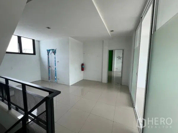 Warehouse for rent in Bang Phli, Samut Prakan - Upper landing with window, staircase and corridor leading to office rooms with glossy tiles.