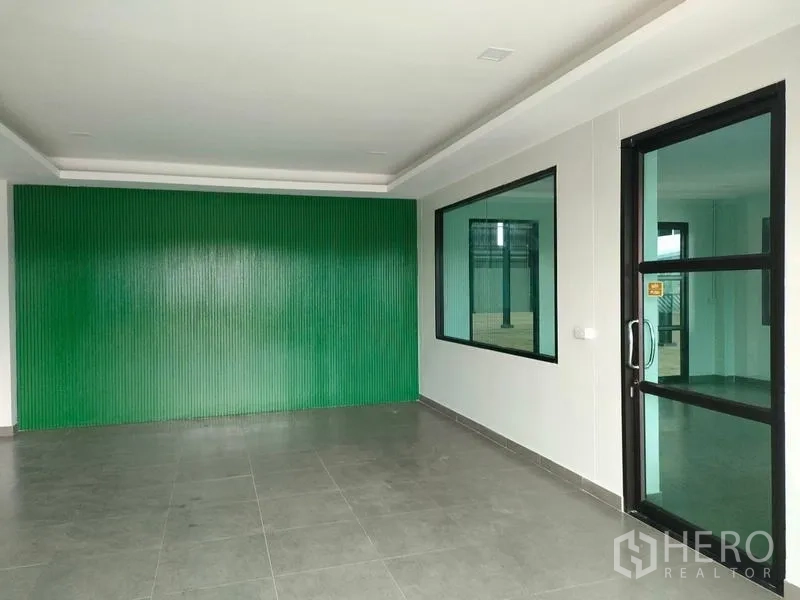 Factory for rent in Ban Phaeo, Samut Sakhon - Office lobby with green feature wall and glass door to factory.
