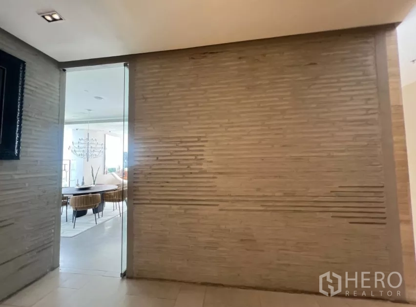 Retail Space for rent - Textured feature wall and frameless glass doorway beside the retail area.