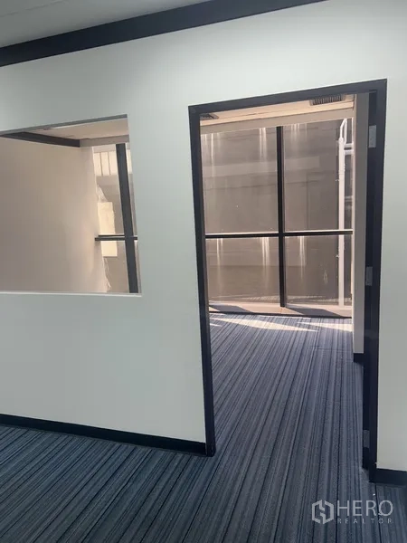 Office Space for rent in Pathum Wan, Bangkok - Doorway leading to a windowed room that brings daylight into the compact office.