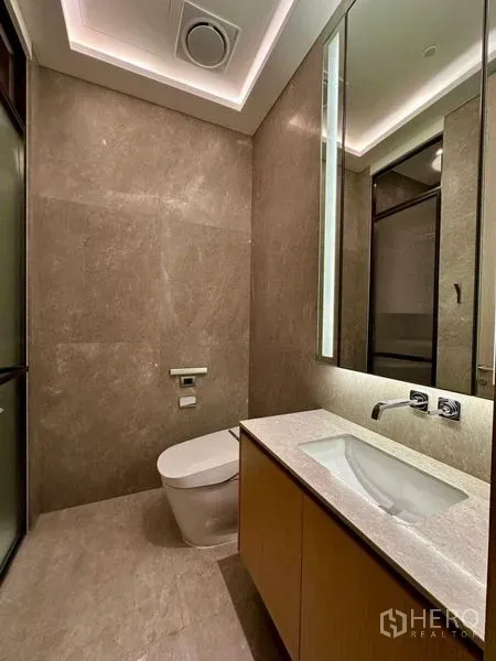 Condominium for rent or sale - Contemporary powder room with stone finishes, floating vanity and wall-hung toilet.
