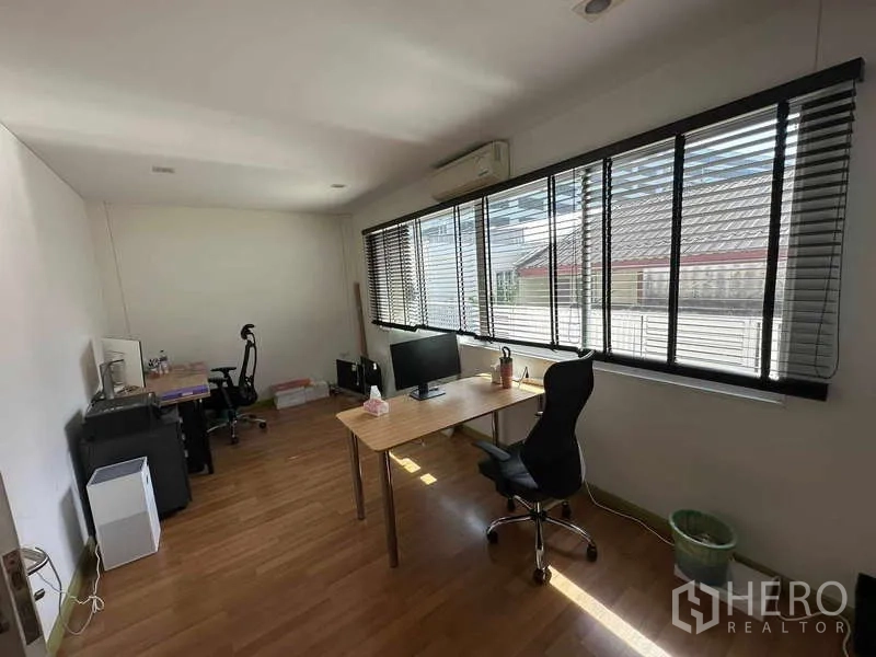 Home Office for rent in Chatuchak, Bangkok - Upper-floor office room with long windows, blinds, desks, and chairs.