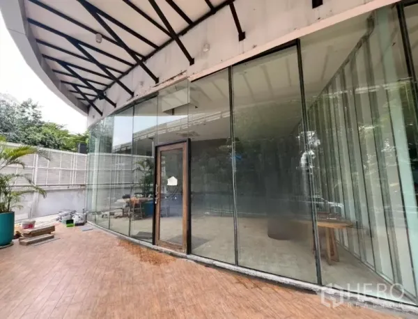 Retail Space for rent - Wide view of the floor-to-ceiling glazed shopfront and covered terrace outside the retail space.