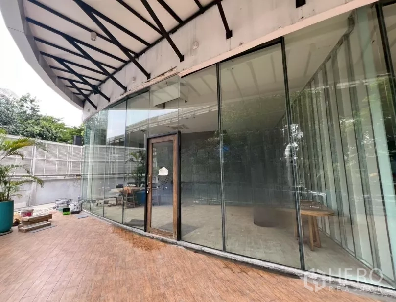 Retail Space for rent - Wide view of the floor-to-ceiling glazed shopfront and covered terrace outside the retail space.
