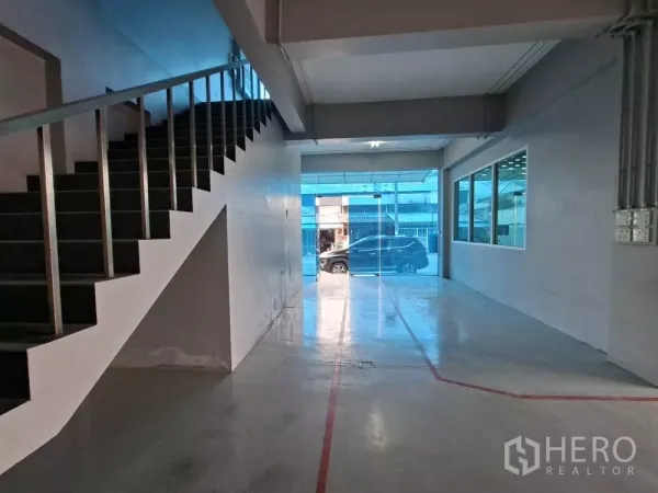 Warehouse for rent in Suan Luang, Bangkok - Ground floor entry with glass front, polished floor and stairway leading up to the office level.