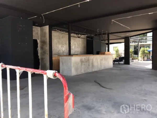 Retail Space for rent in Khlong Toei, Bangkok - Open-plan retail interior with concrete floor, long service counter and exposed ceiling structure.