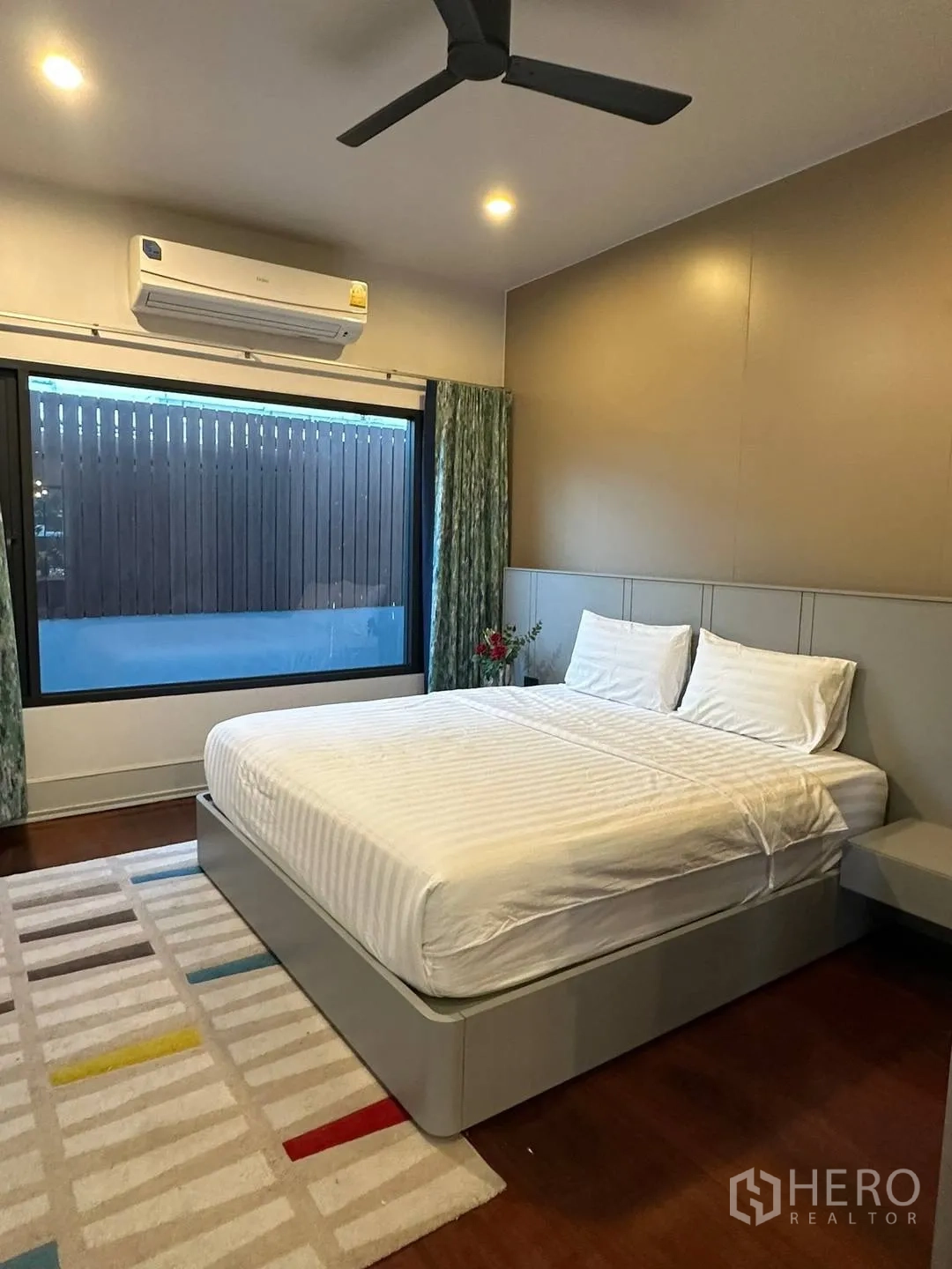 Detached House for rent in Watthana, Bangkok - Guest bedroom with ceiling fan, air conditioner and modern bed.