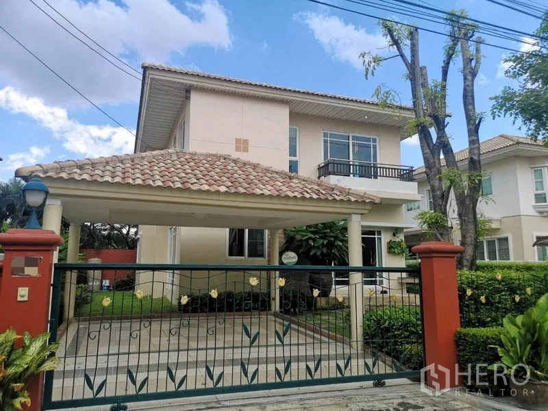 Detached House for rent - Two-storey detached house with tiled roof, gated driveway and covered carport amid landscaped garden in Prawet.