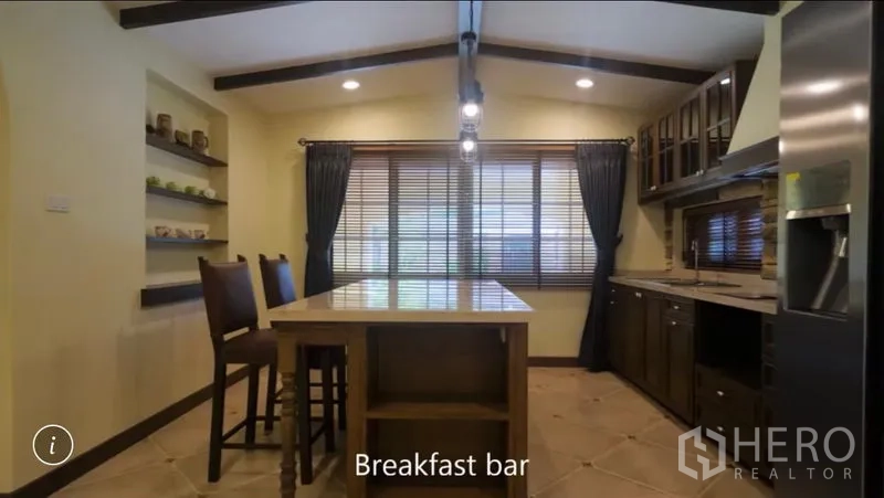 Detached House for rent or sale in Bang Phli, Samut Prakan - Breakfast-bar kitchen with central island, pendant lights and wide windows with blinds.