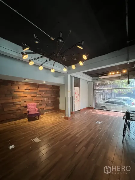 Retail Space for rent in Watthana, Bangkok - Warm wood-floored retail space with feature wall and large front window near BTS Phrom Phong.