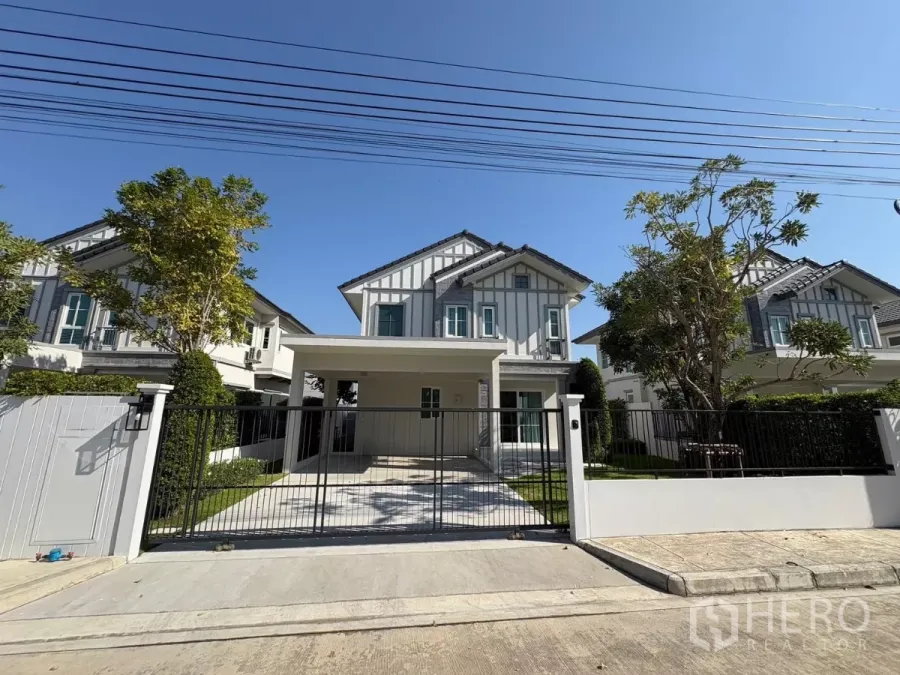 Detached House for rent in Bang Phli, Samut Prakan - Modern two-storey detached house with gated driveway and lawn in a secure community.