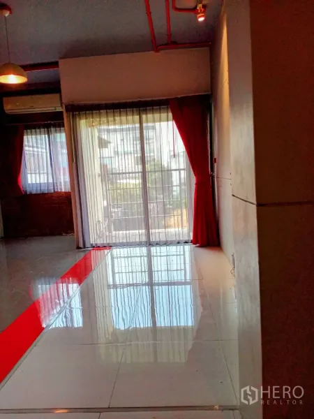 Office Space for rent in Khlong Toei, Bangkok - Bright workspace facing large balcony doors with a red accent strip on the floor.