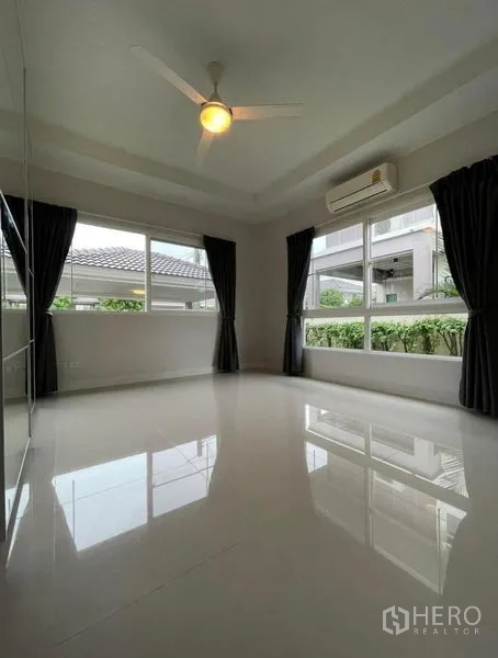 Detached House for sale in Bang Phli, Samut Prakan - Corner bedroom with glossy floors, air-conditioning, ceiling fan and multiple windows.