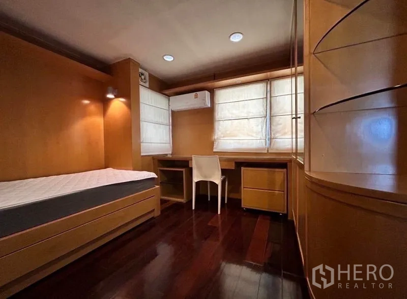 Home Office for rent in Suan Luang, Bangkok - Cozy bedroom with built-in desks, warm wood paneling and flooring.