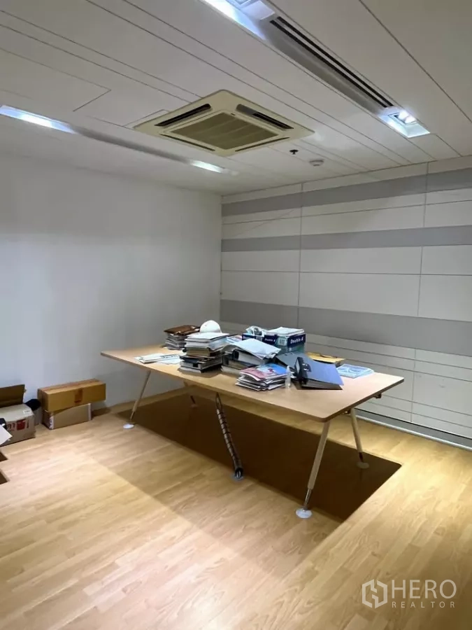 Office Space for rent in Khlong Toei, Bangkok - Private meeting room with wooden flooring, long table and striped wall panels.